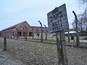 A warning sign near a barbed wire fence at the former Auschwitz concentration camp run by Nazi Germans in Oswiecim, Poland.