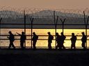 South Korean soldiers patrol along a military fence near the demilitarized zone dividing the two Koreas.
