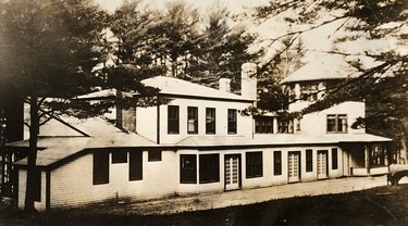 A large residence surrounded by trees.