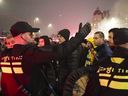 In this image taken from video, police escort Maccabi Tel Aviv supporters to the metro station leading them to the Ajax stadium, after pro-Palestinian supporters marched near the stadium, in Amsterdam, the Netherlands, Thursday, Nov. 7, 2024.