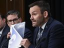 Parti Quebecois Leader Paul St-Pierre Plamondon holds a party document at a news conference to unveil their plan on immigration, Monday, October 28, 2024 at the legislature in Quebec City.