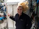 NASA astronaut Kate Rubins points to the International Space Station's