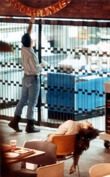 A police officer works in the school’s cafeteria, near the body of one young woman who was killed in the attack on Dec. 6, 1989.