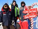 Local striking Canada Post workers Carrie Graham, left, Ryan Pawlowski and Edward Carey stand near a mailbox recently set up by strikers to accept Santa letters at the Canada Post location on Lasalle Boulevard in Sudbury, Ont. on Friday December 13, 2024.