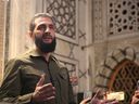 The leader of Syria's Islamist Hayat Tahrir al-Sham group, Abu Mohammed al-Jolani, addresses a crowd in Damascus on Sunday.