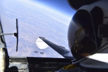 An air force jet pilot looks down at a Chinese surveillance balloon as it hovers over the United States on Feb. 3, 2023.
