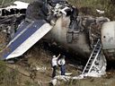 Investigators review the remains of the Air France plane which crashed on landing, at Pearson Airport in Toronto, on Aug. 3, 2005.