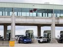 Canada Border Services Agency officers speak with travellers crossing at the Niagara Falls International Rainbow Bridge in Niagara Falls, Ont., Friday, June 7, 2024.