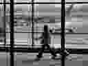A traveller passes Air Canada planes at Pearson International Airport in Toronto, Ont.