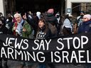 Protesters outside of the Confederation Building near Parliament Hill call for an arms embargo against Israel in Ottawa, on Tuesday, Dec. 3, 2024.