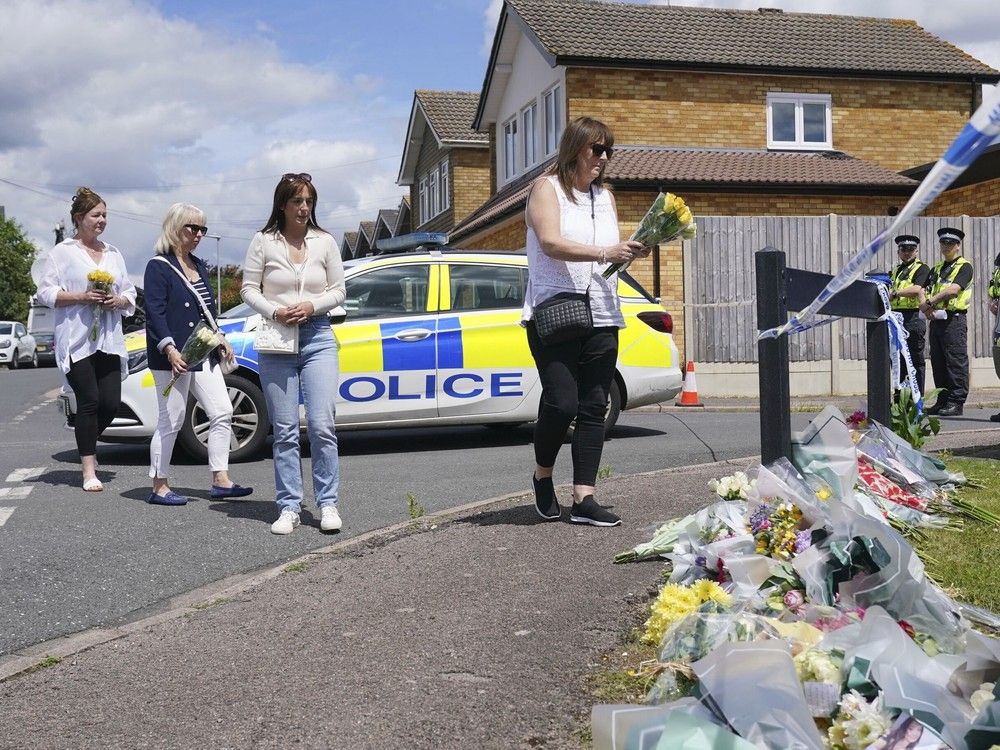  Family friend Lea Holloway, left, arrives with others to place tributes following the deaths of three women who were killed in an attack at their home, on Tuesday in Bushey, England, Thursday July 11, 2024.