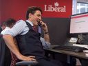 Prime Minister Justin Trudeau works the phones at Liberal headquarters in Ottawa, Oct. 19, 2016.