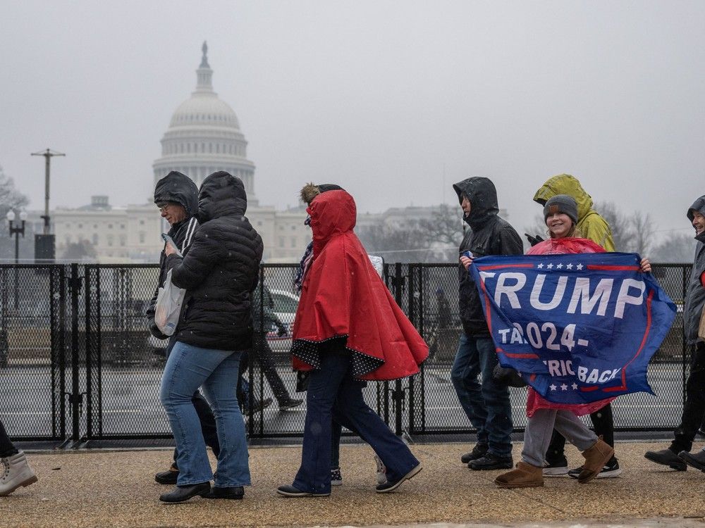 Supporters of US President-elect Donald Trump line up on the National Mall near the US Capitol for a MAGA victory rally at Capital One Arena in Washington, DC, on January 19, 2025, one day ahead of Trump's inauguration. 