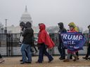 Supporters of US President-elect Donald Trump line up on the National Mall near the US Capitol for a MAGA victory rally at Capital One Arena in Washington, DC, on January 19, 2025, one day ahead of Trump's inauguration.
