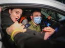 Friends reach out to British-Israeli hostage Emily Damari as she arrives at Sheba Medical Center, also known as Tel HaShomer Hospital, where hostages are arriving after the first phase of a ceasefire agreement began between Israel and Hamas, on Jan. 19, 2025 in Ramat Gan, Israel.