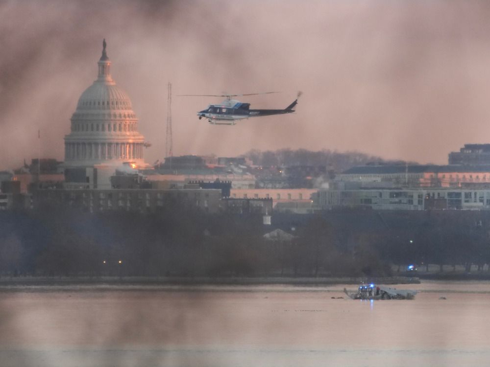 NextImg:Passenger jet collides with Army helicopter while landing at Reagan Airport near DC