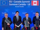 Prime Minister Justin Trudeau, second from left, signs a free-trade deal during the EU-Canada summit meeting, in Brussels in 2016.