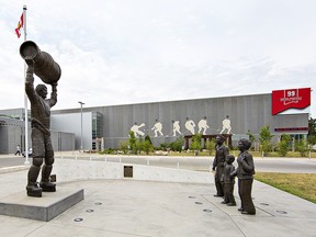 Statues of Phyllis and Walter Gretzky, with a young Wayne sporting a Gordie Howe jersey, look toward a statue of No. 99 in an Oilers uniform hoisting the Stanley Cup, at the Wayne Gretzky Sports Centre in Brantford, Ont.