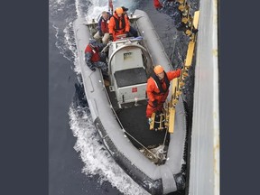 Sailors in a small boat.