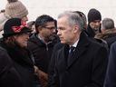 Liberal leadership candidate Mark Carney speaks with people before a ceremony at the National Holocaust Monument, Monday, Jan 27, 2025 in Ottawa.
