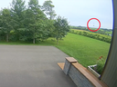 A frame from the security camera at Joe Velaidum's home shows the space rock (circled) a fraction of a second before it hits the ground.