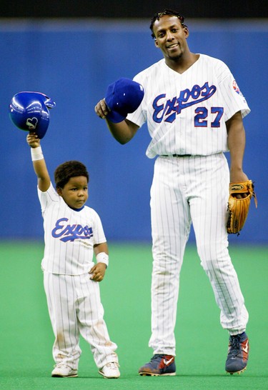 Montreal Expos' Vladimir Guerrero and son Vladimir Jr. tip their caps to the crowd after Guerrero struck out in the eighth inning against Cincinnati Reds pitcher Joey Hamilton Sunday, Sept. 29, 2002 in Montreal.