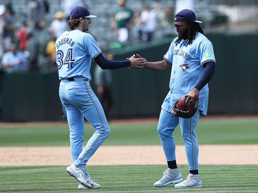 Kevin Gausman and Vladimir Guerrero Jr. of the Toronto Blue Jays celebrate a win against the Oakland Athletics at Oakland Coliseum on June 8, 2024 in Oakland, California.