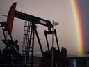 A rainbow appears to come down on pumpjacks drawing out oil and gas from wells near Calgary on Monday, Sept. 18, 2023. THE CANADIAN PRESS/Jeff McIntosh
