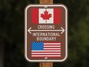A sign marks the border between the United States and Canada at Peace Arch Park on February 1, 2025 in Blaine, Washington.