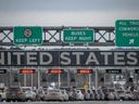 Cars wait in line to enter the United States at a border crossing at the Canada-U.S. border in Blackpool, Quebec, Canada, on February 2, 2025.