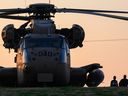 A silhouetted IDF officer (top, left) checks a helicopter before taking off again after bringing released Israeli hostage Arbel Yehoud to Sheba Medical Center on January 30, 2025 in Ramat Gan, Israel.