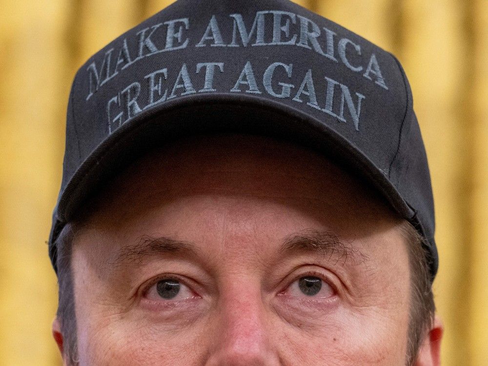 TOPSHOT - Tesla and SpaceX CEO Elon Musk looks on before US President Donald Trump signs executive orders in the Oval Office of the White House in Washington, DC, on February 11, 2025. Tech billionaire Elon Musk, who has been tapped by President Donald Trump to lead federal cost-cutting efforts, said the United States would go 