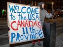 A fan holds a sign outside TD Garden in Boston on February 20, 2025, during the last game of the Four Nations Face-Off hockey tournament between the United States and Canada.