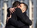 Ukrainian President Volodymyr Zelensky, right, and Canada's Prime Minister Justin Trudeau embrace prior to a ceremony to mark the third anniversary of the Russian invasion of Ukraine.