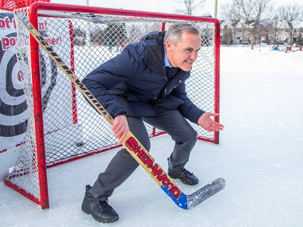To the layman, this is just Liberal leadership candidate Mark Carney pretending to play hockey at a campaign event with David McGuinty. But according to an eagle-eyed fashion watcher, Carney is wearing a pair of $2,000 Italian-made Zegna sneakers.