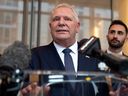 Ontario Premier Doug Ford, with Ontario Energy Minister Stephen Lecce, speaks to reporters after an event at the U.S. Chamber of Commerce in Washington, Tuesday, Feb. 11, 2025.