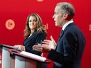 Candidate Chrystia Freeland looks over as Mark Carney speaks during the English-language Liberal leadership debate in Montreal on Tuesday, Feb. 25, 2025.