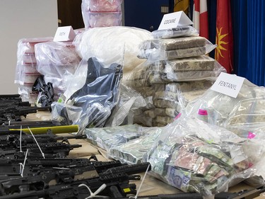 An assortment of drugs, cash and weapons seized by the RCMP following the dismantling of a massive drug lab in Falkland, B.C., on Oct. 25, 2024.