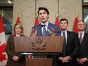 Canada's Prime Minister Justin Trudeau speaks during a news conference about the US tariffs against Canada on March 4, 2025 on Parliament Hill in Ottawa, as (L-R) Foreign Minister Melanie Joly, Minister of Finance and Intergovernmental Affairs Dominic Leblanc and Minister of Public Safety David McGuinty look on. (Photo by DAVE CHAN/AFP via Getty Images)
