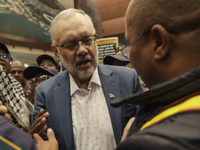 Former South African Ambassador to the United States Ebrahim Rasool speaking to a South African man