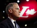 Liberal Party of Canada leadership candidate Mark Carney looks on as Prime Minister Justin Trudeau delivers a speech during the Liberal leadership announcement in Ottawa on Sunday, March 9, 2025. THE CANADIAN PRESS/Sean Kilpatrick