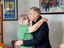 Prime Minister Mark Carney gets a hug from Beulah Cooper as he arrives at her house in Gander, N.L., on Monday March 24, 2025. Cooper housed stranded U.S. passengers during 9/11 and is featured in the musical Come From Away.