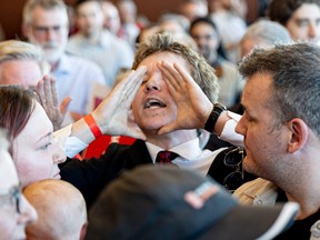 A man in the crowd interrupts Mark Carney