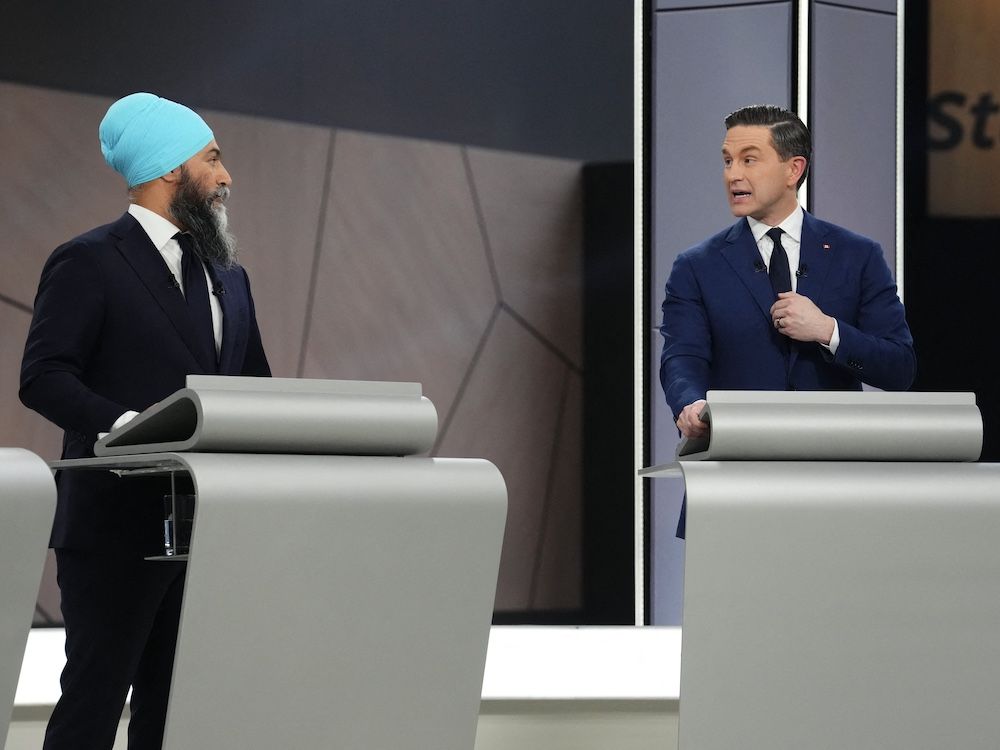 NextImg:Tasha Kheiriddin: Mark Carney gets a free ride as Poilievre dukes it out with Singh