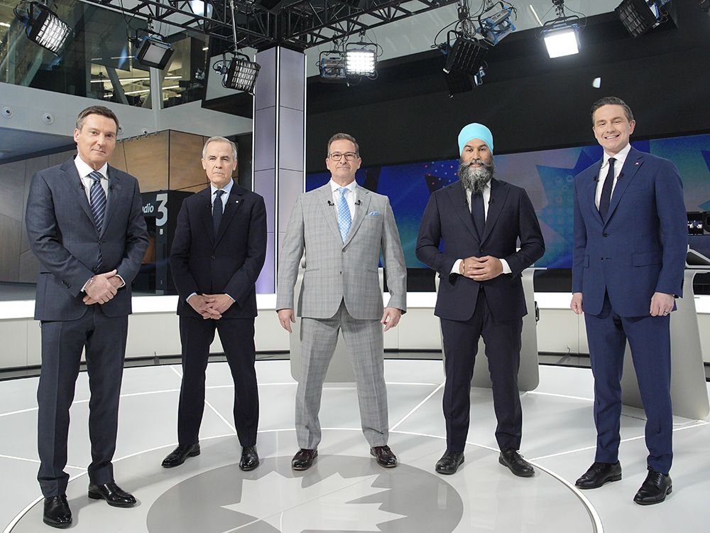  Moderator Patrice Roy stands with Liberal leader Mark Carney, Bloc Quebecois Leader Yves-Francois Blanchet, New Democratic Party Leader Jagmeet Singh and Conservative Leader Pierre Poilievre before the French-language federal leaders’ debate, in Montreal, April 16, 2025.