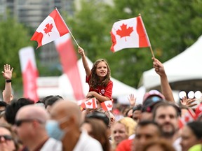 People waving Canadian flags.