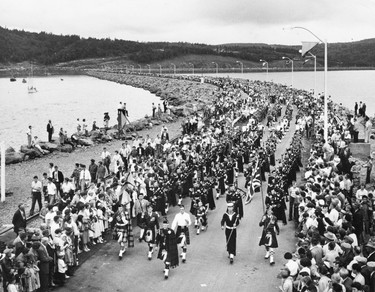 Pipers march across the Canso Causeway at its official opening, Aug. 13, 1955.