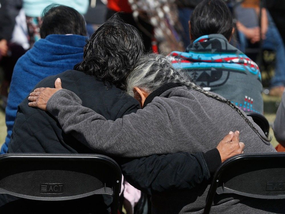  People embrace at a press conference by officials at the James Smith Cree Nation on September 8, 2022. – A days-long search for the second man suspected of carrying out a deadly stabbing spree in a remote western Canadian Indigenous community ended September 7, with the 32-year-old dying after being taken into custody, police said.