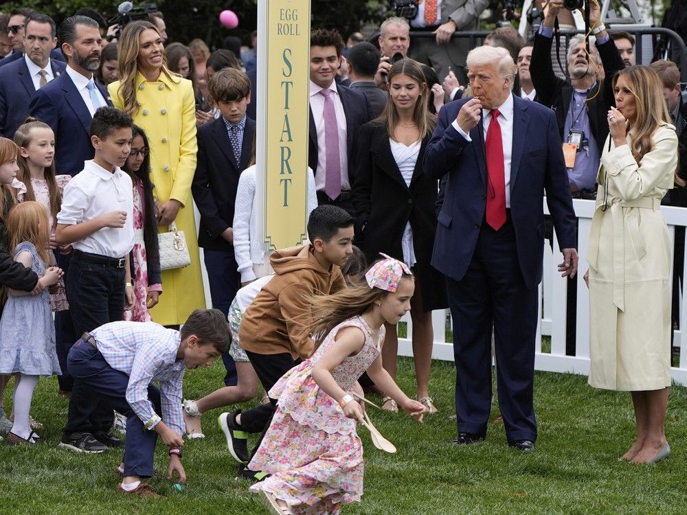  President Donald Trump and first lady Melania Trump blow whistles during the White House Easter Egg Roll on the South Lawn of the White House, Monday, April 21, 2025, in Washington.