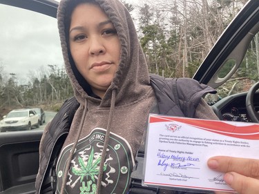 Hilary Maloney-Nevin holds her license issued by Sipekne'katik First Nation under its self-governed elver fishery.